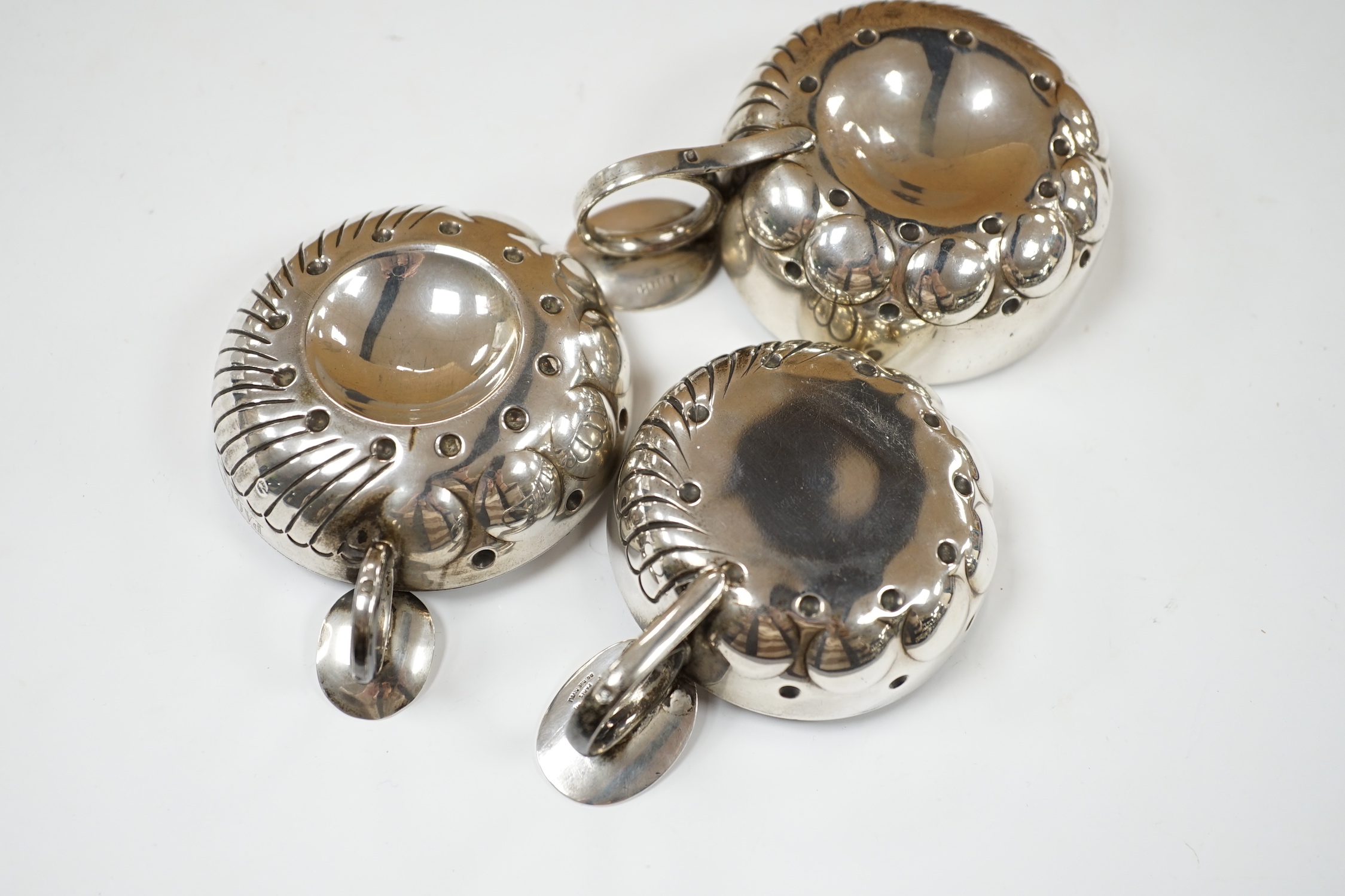 Three assorted late 19th/early 20th century French white metal taste vin, largest 11.1cm over handle.